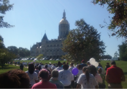 Participants walk in front of the Connecticut State Capitol